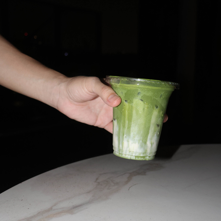 Matcha being poured over ice into a cup